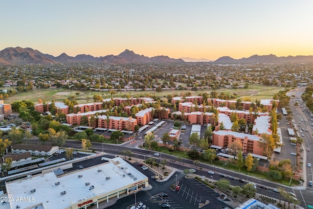 aerial view at dusk featuring a mountain view