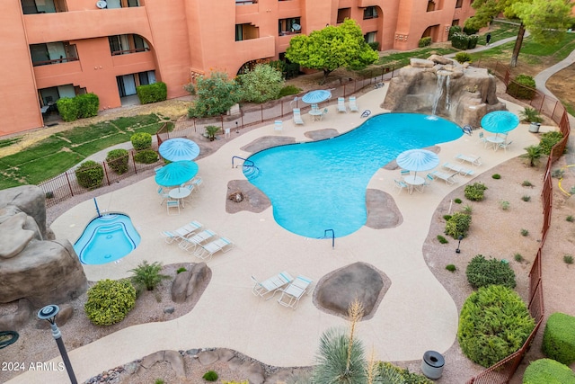 view of swimming pool featuring pool water feature and a patio