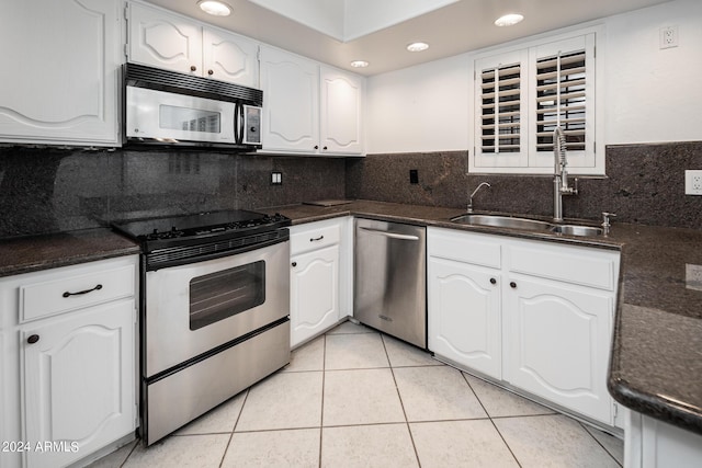 kitchen featuring light tile patterned floors, white cabinetry, sink, and appliances with stainless steel finishes