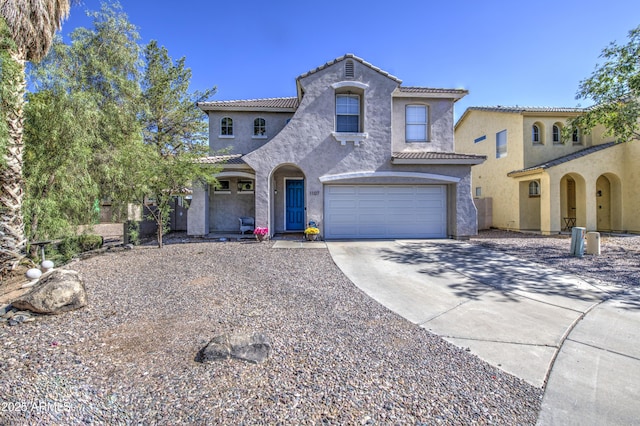 1107 E Ln Salle St, Phoenix, AZ 85040 - mediterranean / spanish house with driveway, stucco siding, a garage, and a tiled roof