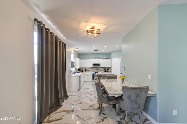 1107 E Ln Salle St, Phoenix, AZ 85040 - dining space featuring light marble finish floors and recessed lighting