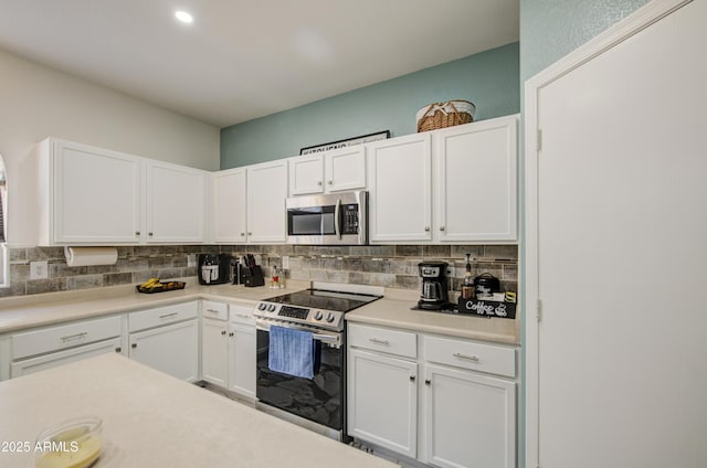 1107 E Ln Salle St, Phoenix, AZ 85040 - kitchen with stainless steel appliances, backsplash, white cabinetry, and recessed lighting