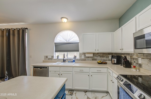 1107 E Ln Salle St, Phoenix, AZ 85040 - kitchen with appliances with stainless steel finishes, backsplash, white cabinetry, and light countertops