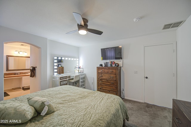 1107 E Ln Salle St, Phoenix, AZ 85040 - bedroom with arched walkways, carpet floors, ceiling fan, and ensuite bath