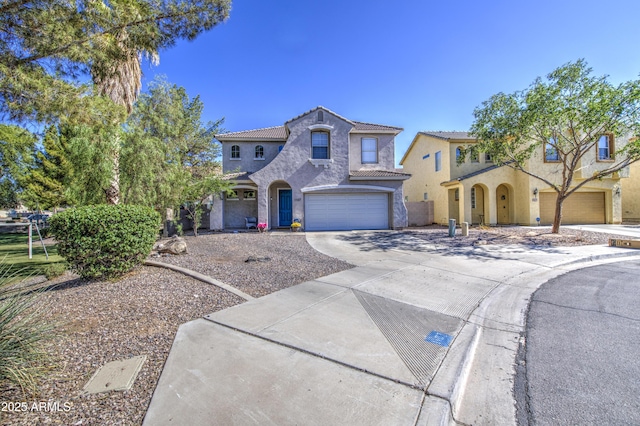 1107 E Ln Salle St, Phoenix, AZ 85040 - mediterranean / spanish home with an attached garage, concrete driveway, stucco siding, and a tiled roof