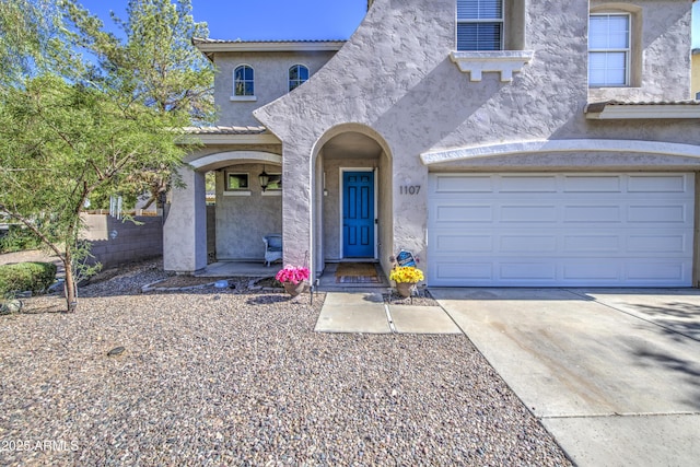 1107 E Ln Salle St, Phoenix, AZ 85040 - view of front facade with stucco siding, driveway, a garage, and a tile roof