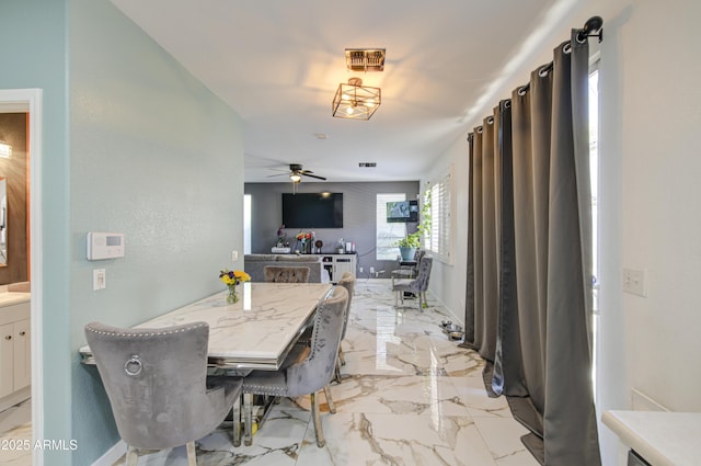 1107 E Ln Salle St, Phoenix, AZ 85040 - dining space featuring light marble finish floors and a ceiling fan
