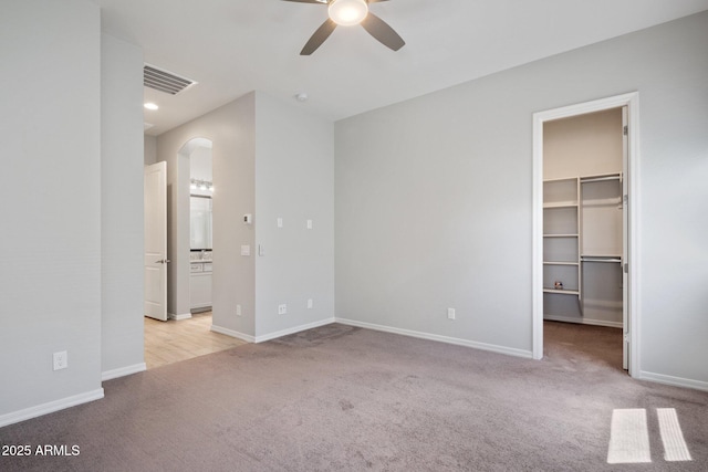 2644 S Dock St, Gilbert, AZ 85295 - unfurnished bedroom featuring visible vents, baseboards, light colored carpet, a spacious closet, and arched walkways