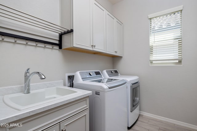 2644 S Dock St, Gilbert, AZ 85295 - washroom with cabinet space, a sink, baseboards, light wood-type flooring, and washing machine and dryer