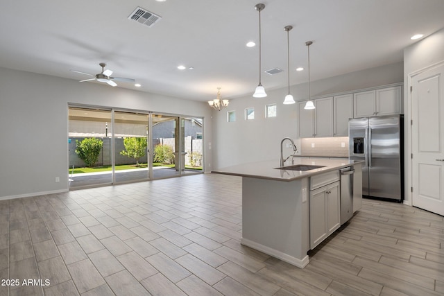 2644 S Dock St, Gilbert, AZ 85295 - kitchen with a sink, ceiling fan with notable chandelier, stainless steel appliances, open floor plan, and visible vents