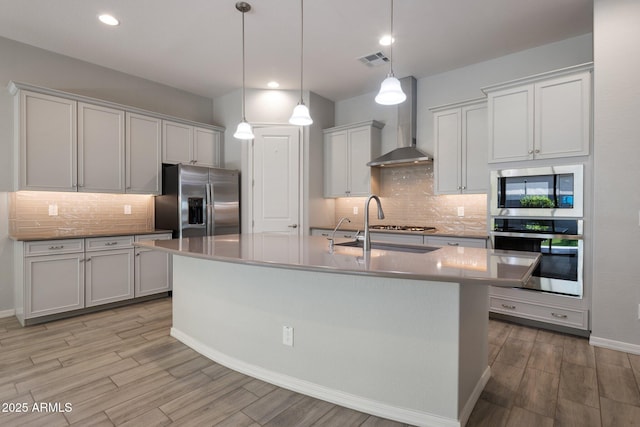 2644 S Dock St, Gilbert, AZ 85295 - kitchen with backsplash, stainless steel appliances, visible vents, and wall chimney exhaust hood