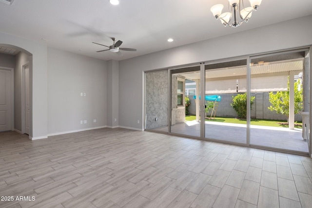 2644 S Dock St, Gilbert, AZ 85295 - empty room with baseboards, arched walkways, ceiling fan with notable chandelier, and wood finished floors