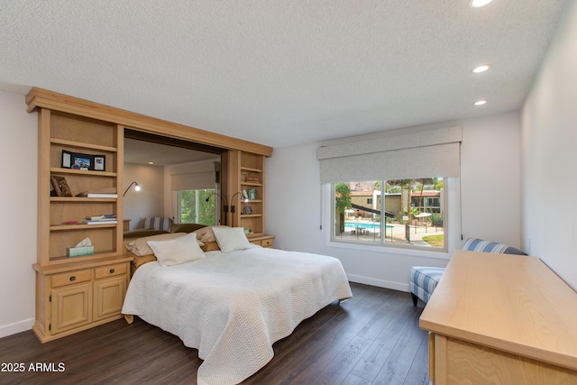 bedroom featuring dark wood-style floors, recessed lighting, a textured ceiling, and baseboards