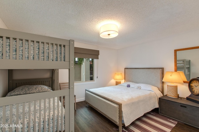 bedroom featuring a textured ceiling and wood finished floors