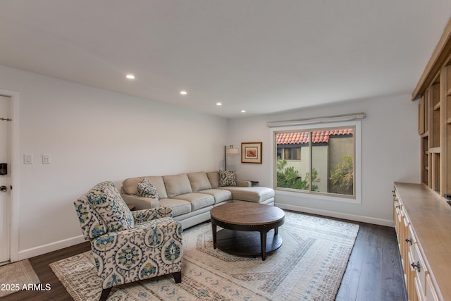 living room featuring recessed lighting, baseboards, and dark wood-style floors