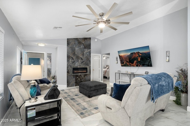 living room with ceiling fan, lofted ceiling, and a fireplace