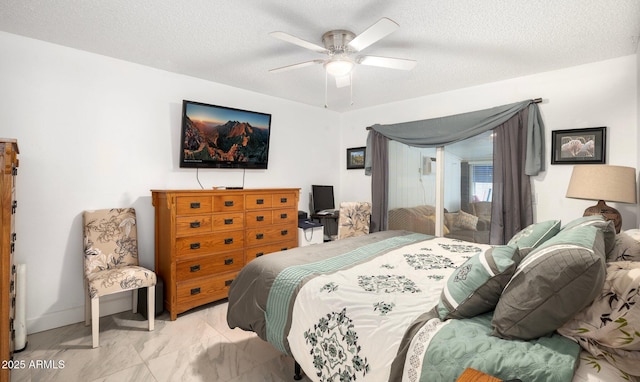 bedroom with a textured ceiling and ceiling fan