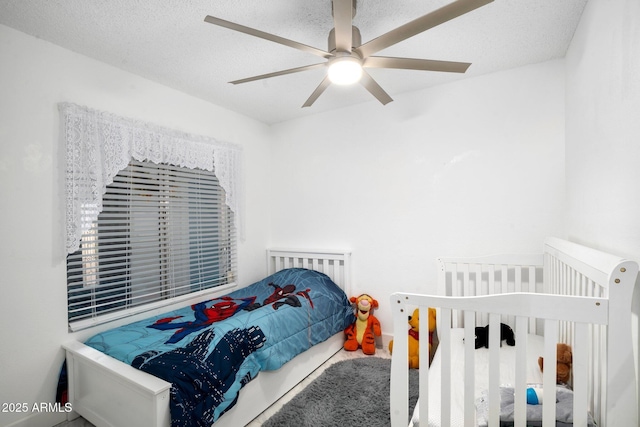 bedroom with a textured ceiling and ceiling fan