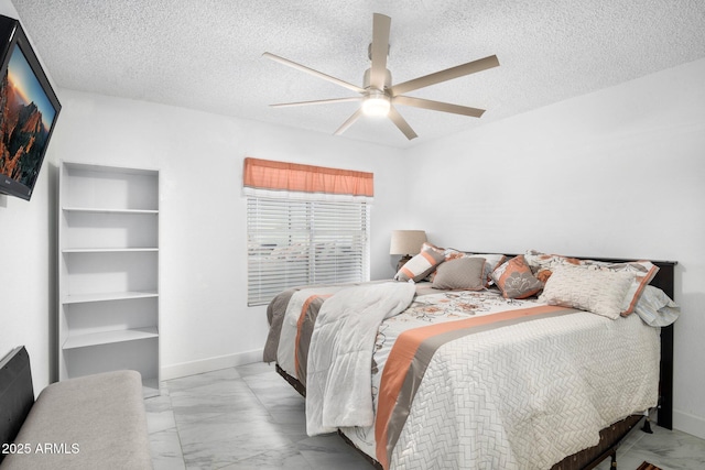 bedroom featuring a textured ceiling and ceiling fan