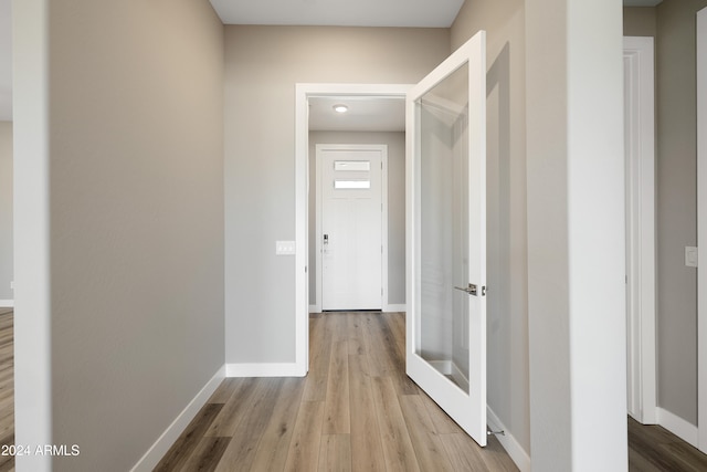 corridor with light hardwood / wood-style flooring