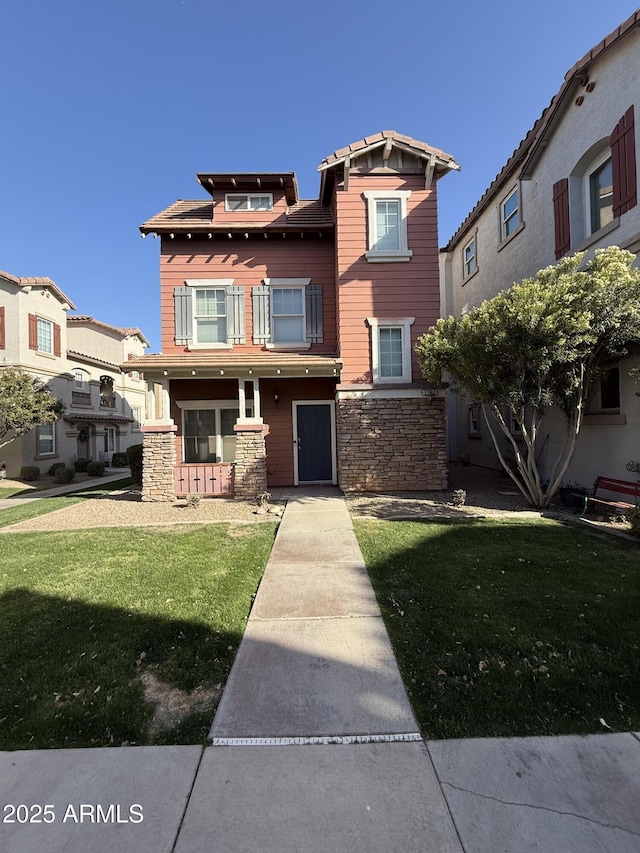 view of front of home featuring stone siding and a front lawn