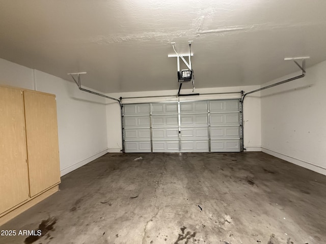 garage with a garage door opener and baseboards