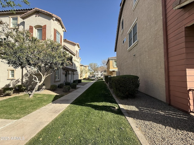 view of community with a residential view and a yard