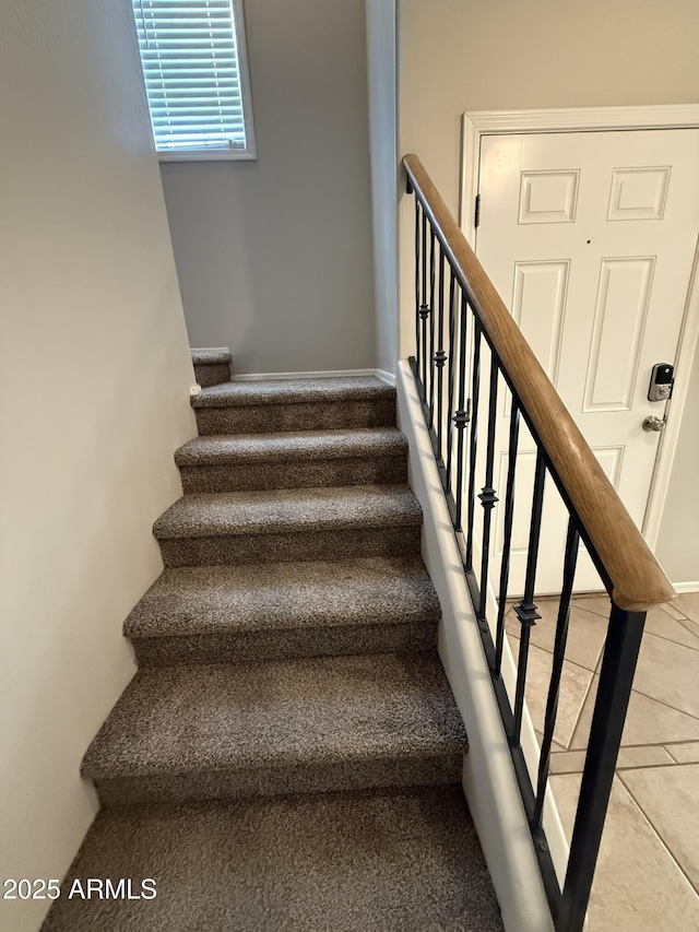 stairs featuring tile patterned floors