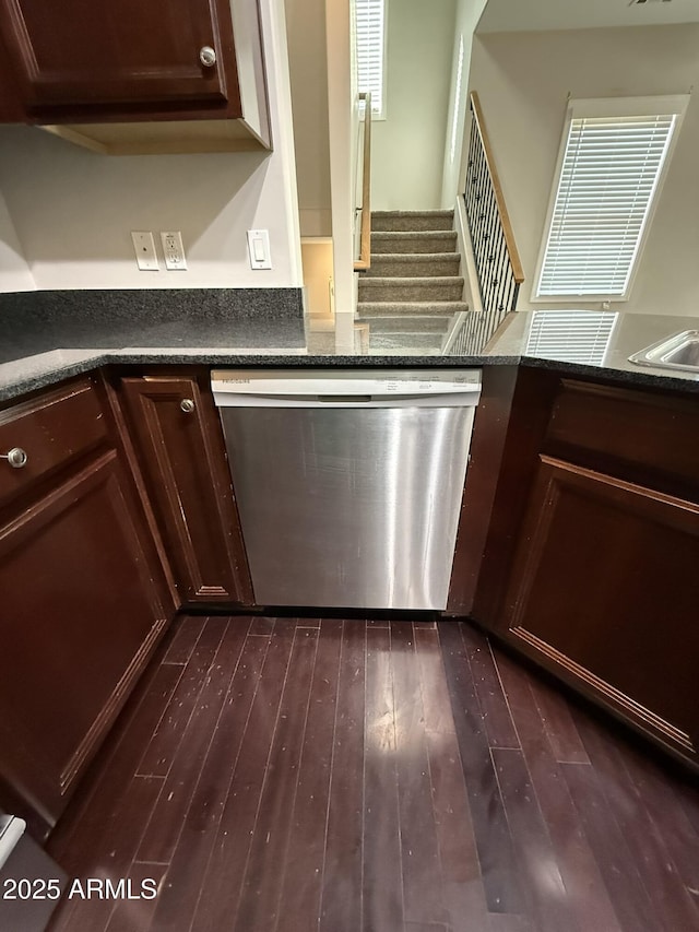 room details featuring dark countertops, dark brown cabinets, dark wood finished floors, and dishwasher