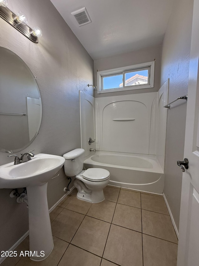 bathroom featuring visible vents, baseboards, toilet, tile patterned flooring, and shower / bathing tub combination