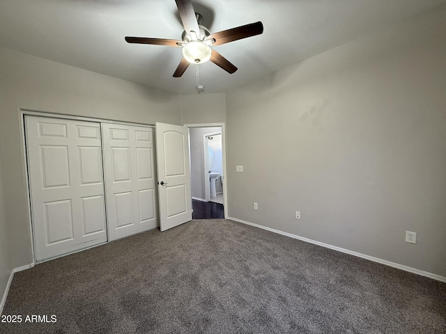 unfurnished bedroom featuring a ceiling fan, baseboards, dark colored carpet, and a closet