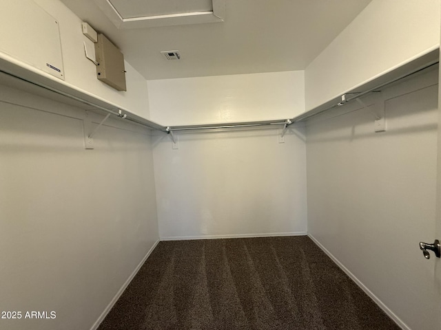 walk in closet with dark colored carpet and visible vents