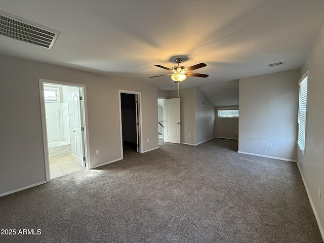 unfurnished bedroom featuring carpet, visible vents, baseboards, and ensuite bathroom