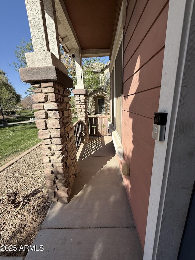 view of side of home featuring covered porch