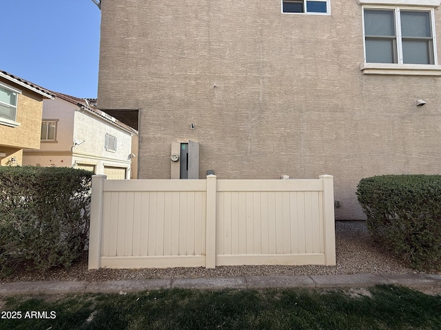 view of property exterior featuring fence and stucco siding