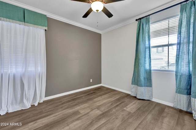 empty room featuring ceiling fan, ornamental molding, and hardwood / wood-style flooring