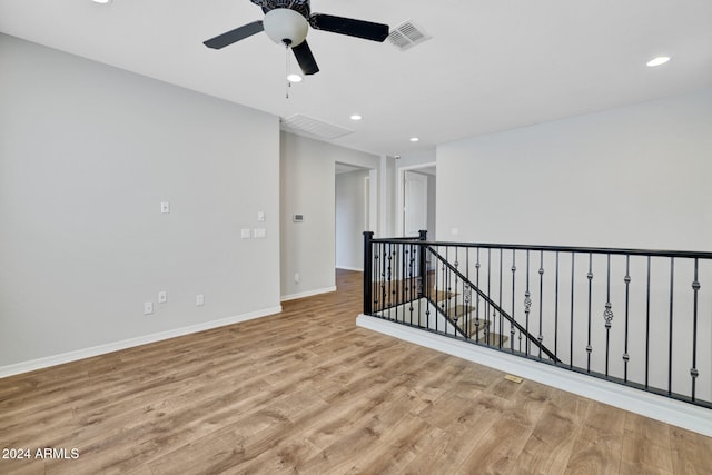 spare room with ceiling fan and light hardwood / wood-style floors