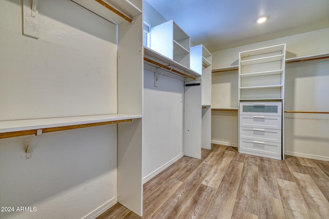 spacious closet featuring light hardwood / wood-style floors