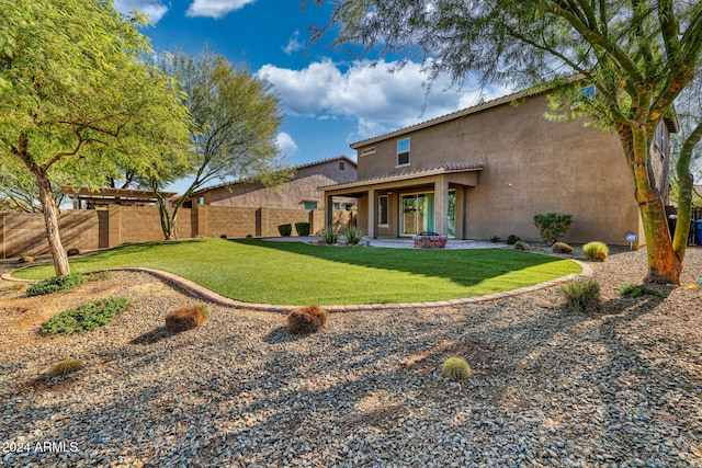 rear view of property featuring a yard