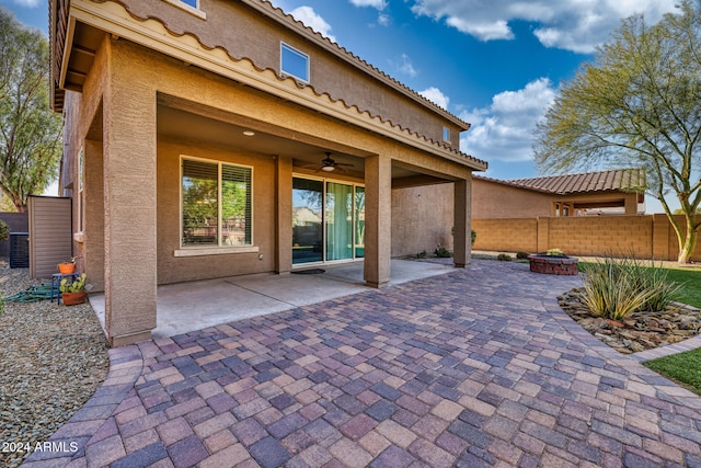 view of patio featuring a fire pit and ceiling fan