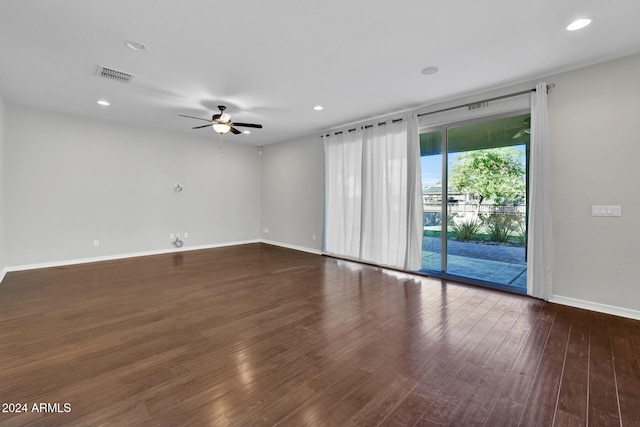 spare room with ceiling fan and dark wood-type flooring