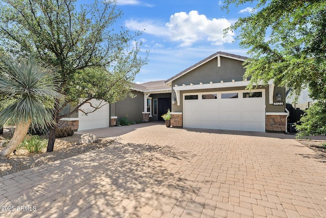 view of front facade featuring stone siding, an attached garage, decorative driveway, and stucco siding