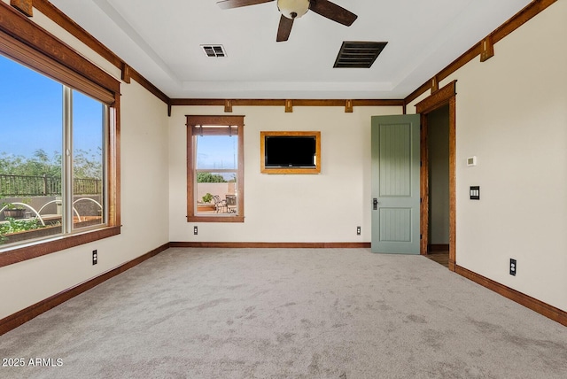 empty room with carpet, ceiling fan, and baseboards