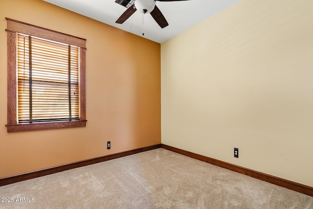 carpeted spare room with ceiling fan, healthy amount of natural light, and baseboards