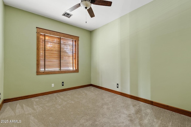 unfurnished room with carpet flooring, a ceiling fan, and baseboards