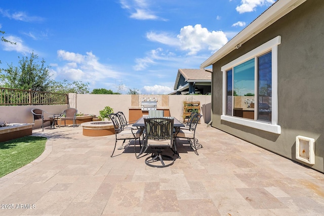view of patio featuring a fire pit, grilling area, fence, and outdoor dining space