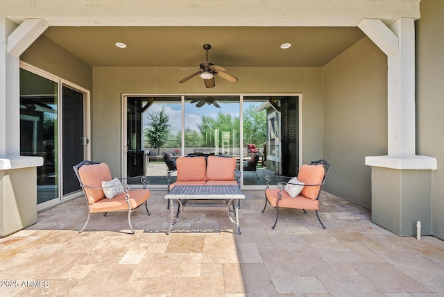 view of patio / terrace with ceiling fan and an outdoor living space