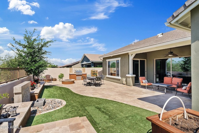 view of yard featuring a ceiling fan, an outdoor fire pit, and a patio area