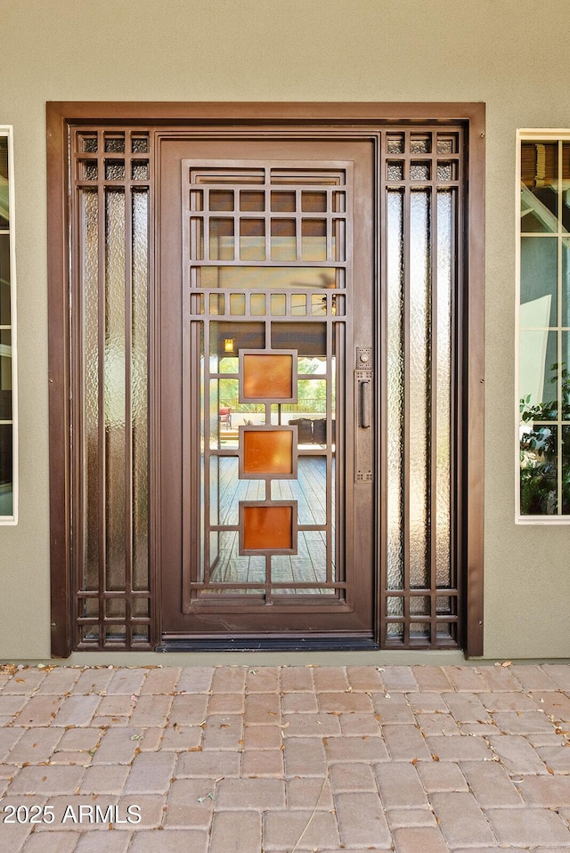 property entrance with stucco siding
