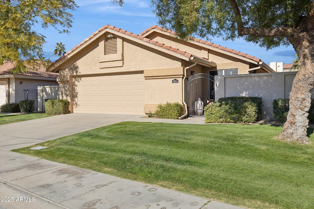 view of front of property featuring a garage and a front yard